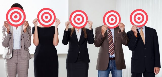 Group of business people holding a target