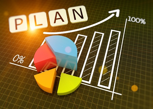 graph paper with rising bar graph and pie chart with 'plan' written on it